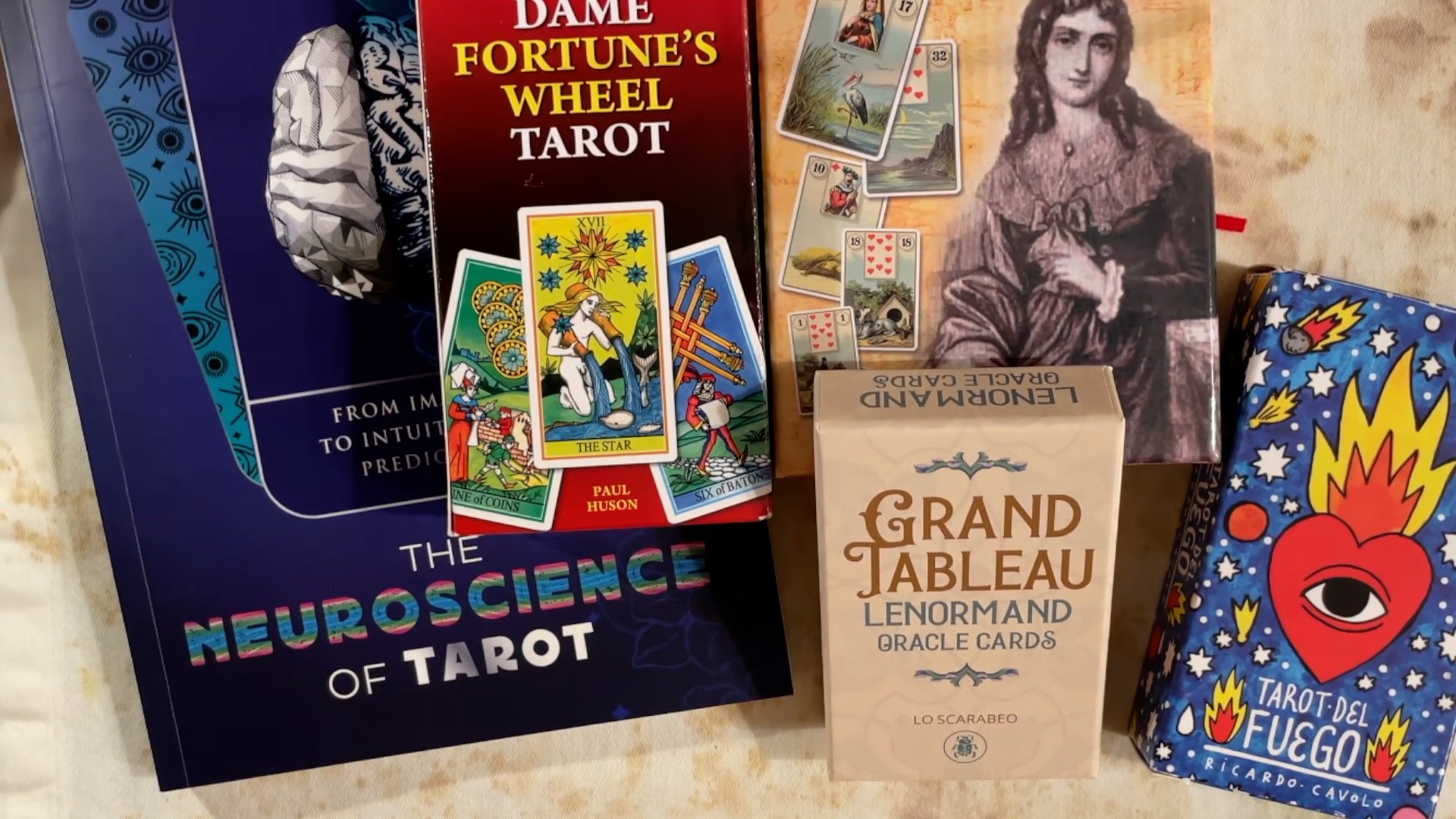 A pile of books and decks I want to read and use in 2026