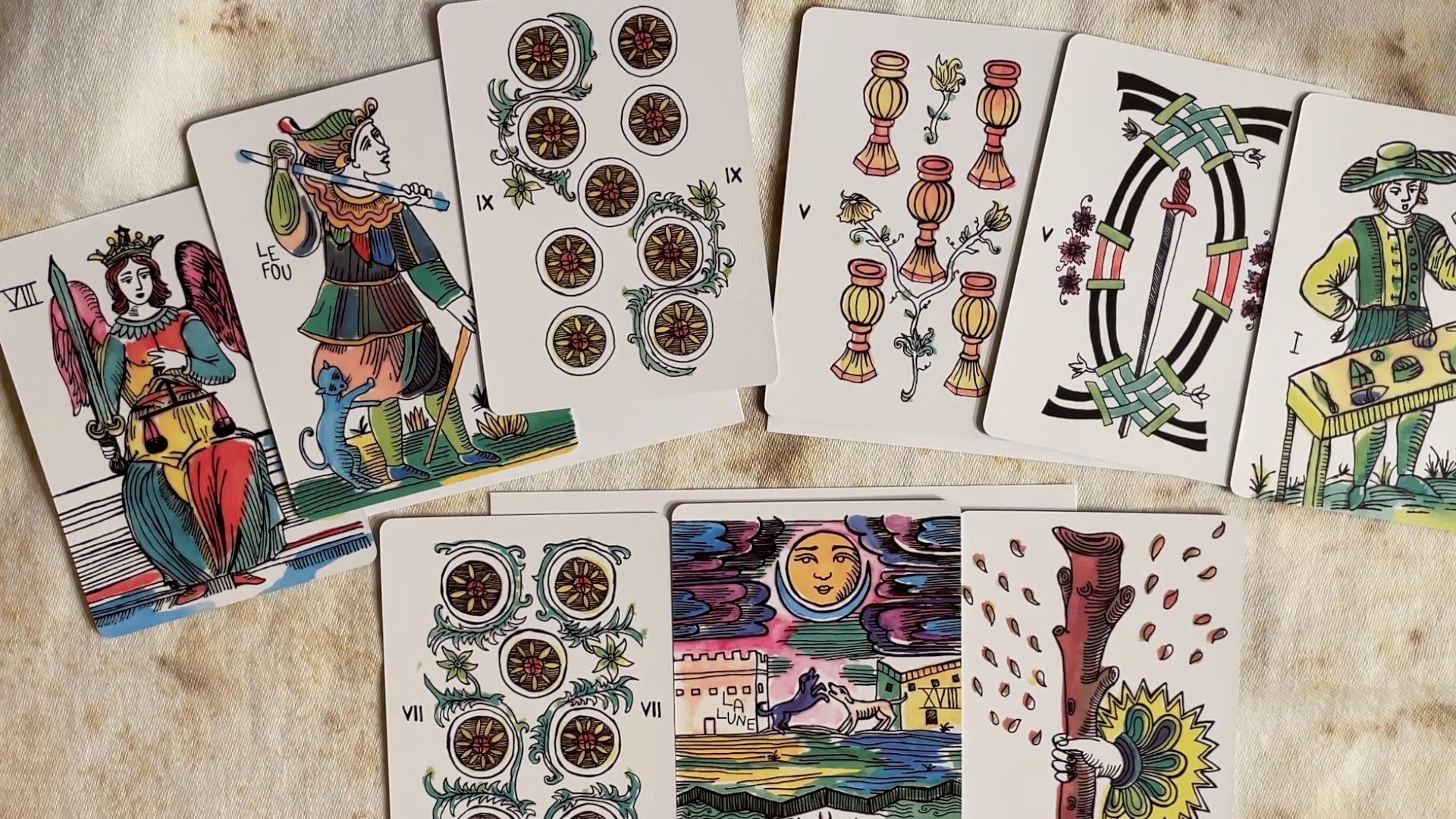 9 cards from the pastel-colored Marshmallow Marseilles, laid out in two rows, 6 above in an arch and 3 below.