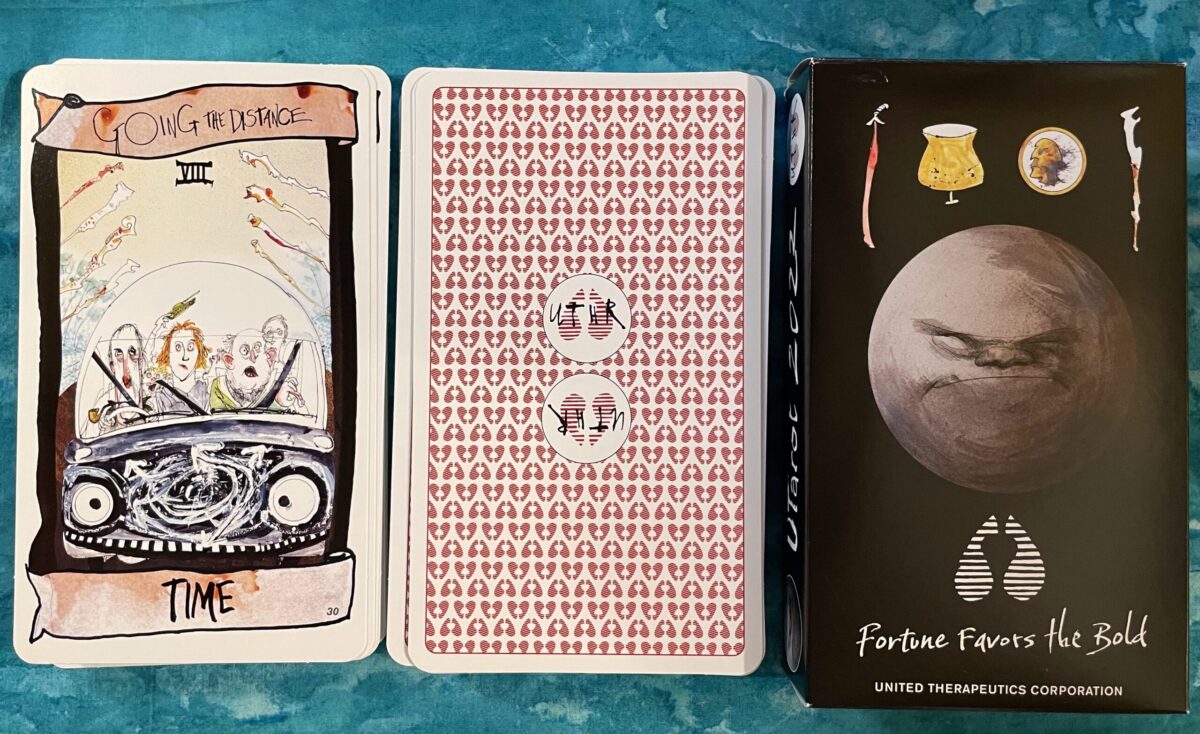The Eight of Wands card, the backs of the cards, and the box for the UTarot 2022 deck.