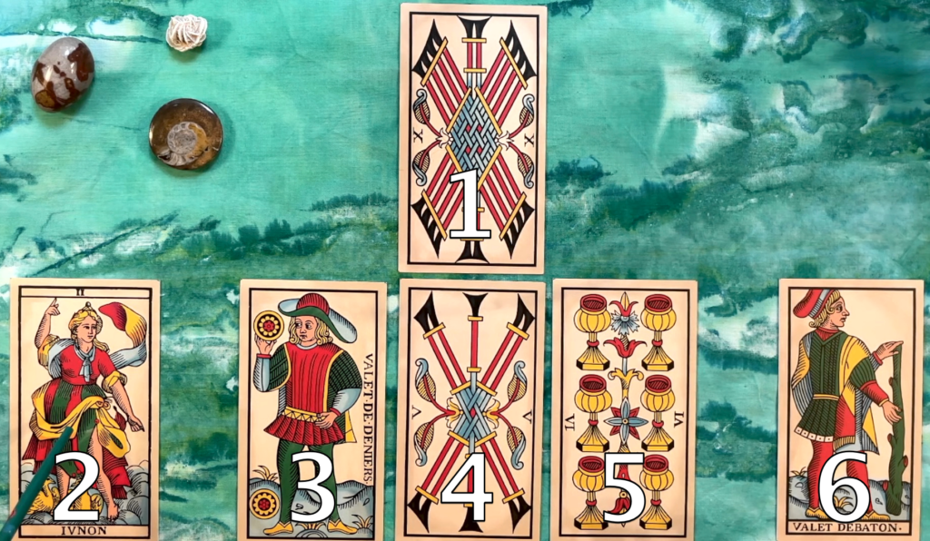 A tarot spread with the first card, the tower that needs tearing down at the top. Cards 2-6 are arranged in a line below, reading from left to right.