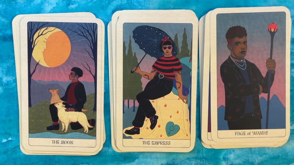 three images from the Modern Goth Tarot, featuring persons of the global majority with medium to dark melanated skin, body piercings, and gothic clothes and accessories